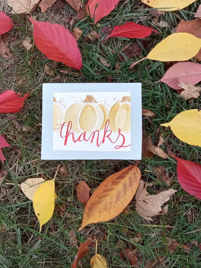 Haley Jula design watercolor art card on a nature background of colorful fall leaves